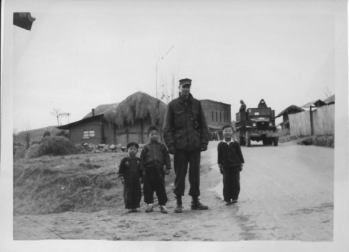 Don Feeney with children in the town of Tukto, near 48th MASH, January, 1954